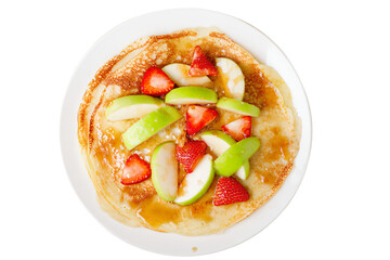 a plate of pancakes with fruit on top
