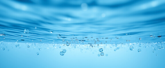 Beautiful closeup reveals the underwater world with clear ripples and floating bubbles in light blue liquid, creating a refreshing aquatic scene.