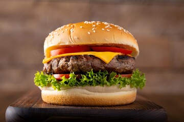 Delicious cheeseburger with dripping cheese and rising steam