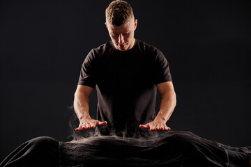 Therapist performing energy massage with hands, offering deep relaxation and holistic healing in...