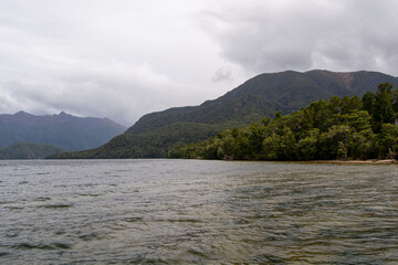 Tranquil Lake Surrounded by Lush Forests and Mountains