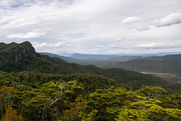 Lush Green Mountain Landscape Under Cloudy Sky