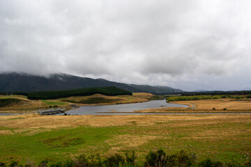 Serene Landscape with Lake and Rolling Hills