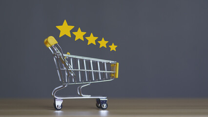 Mini shopping cart with five yellow stars above, symbolizing customer satisfaction, product review,...