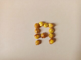roasted chickpeas black and yellow dried, arranged in an A shape.