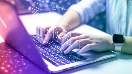 Person typing on laptop with holographic flowchart elements