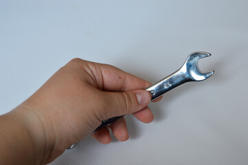 metal wrench with size marking 13 on a white background, ideal for themes like repair, mechanics,...