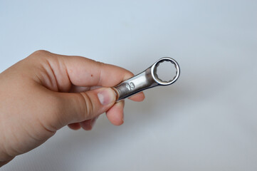 metal wrench with size marking 13 on a white background, ideal for themes like repair, mechanics,...