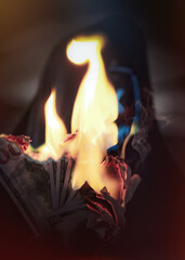 Fiery Close-Up Of Burning Hundred Dollar Bills With Intense Flames In Dark Mysterious Atmosphere,...