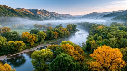 Obraz premium Breathtaking sunrise illuminating foggy river valley in autumn