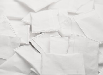 A pile of white ripped paper bags