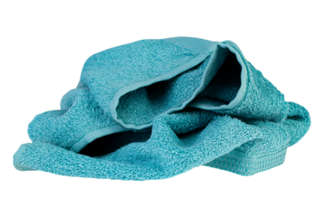 Soft turquoise bath towel crumpled on surface, fluffy cotton texture