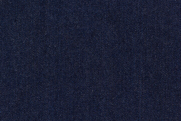 Dark blue denim fabric with detailed weave texture, classic textile material for fashion and design