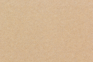 High-resolution brown recycled paper surface showing natural fiber texture, perfect for eco-friendly backgrounds, packaging, or craft design projects.