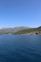 mountain fishing village in the fjords of Montenegro. Bay of Kotor. Vertical photo