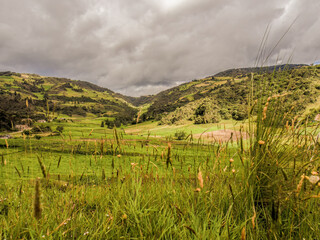 The Andean farm fields and mountains in an overcast sky, around of the town of Sora, near the Iguaque natural reserve in central Colombia.