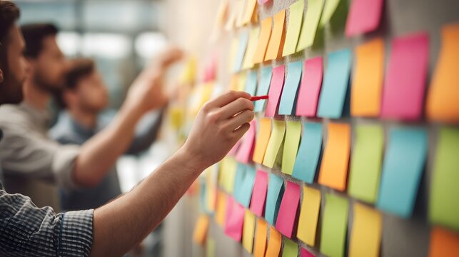 Team brainstorming with colorful sticky notes on wall during a collaborative office meeting session today