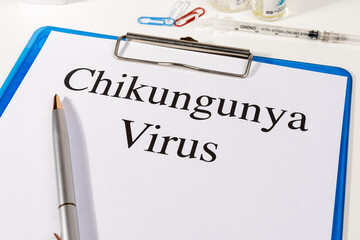 A Paper with “Chikungunya Virus” Title in Clipboard Set on the Desk with Stethoscope –...