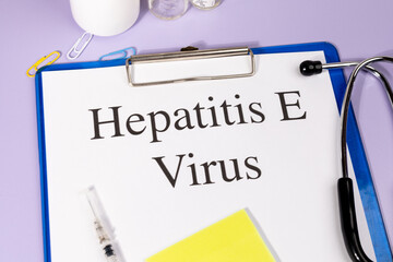 A Paper with “Hepatitis E Virus” Title in Clipboard Set on the Desk with Stethoscope –...