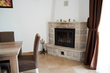 Cozy living room with stone fireplace and elegant dining area