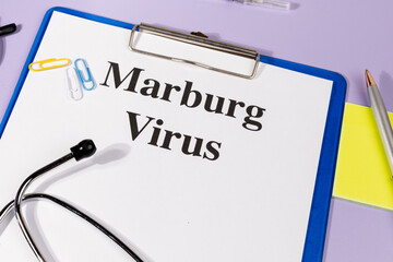 A Paper with “Marburg Virus” Title in Clipboard Set on the Desk with Stethoscope – Viral...