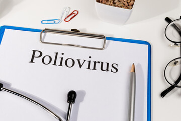 A Paper with “Poliovirus” Title in Clipboard Set on the Desk with Stethoscope – Paralysis and...
