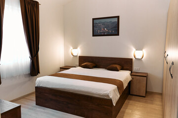 Cozy minimalist bedroom design with wooden bed frame and wall art
