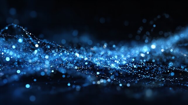 Shimmering blue water drops on glass create a magical winter night sky pattern with bright, sparkling particles and a festive, shiny texture