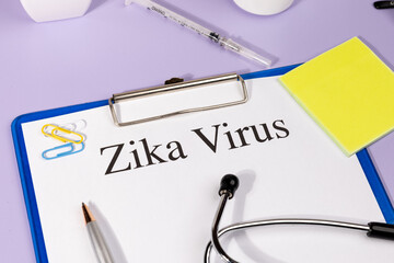 A Paper with “Zika Virus” Title in Clipboard Set on the Desk with Stethoscope – Infectious...