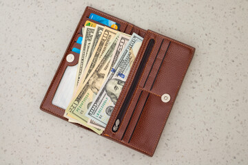 Open Leather Wallet Filled with US Dollar Banknotes