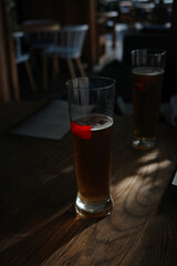 Glasses of light beer with at bar.