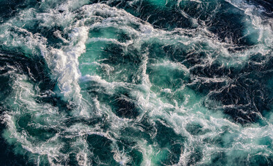 Blue waves of water of the river and the sea meet each other during high tide and low tide.