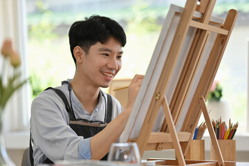 A Young Male Artist Painting in Studio, Creative Studio Moment