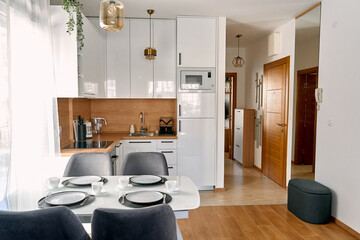 Modern minimalist kitchen and dining area with elegant decor and natural lighting