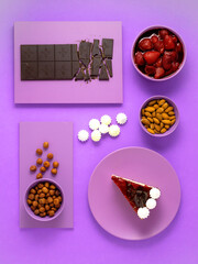 Creative food health diet concept photo of desert dishes chocolate strawberry ice cream on purple background. 
