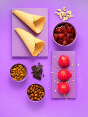 Creative food health diet concept photo of desert dishes chocolate strawberry ice cream on purple background. 