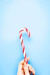 Creative food health diet concept photo of lolli pop popsicle candy on blue background Christmas holiday celebration.