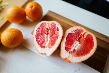 Fresh citrus fruits showcased on a rustic wooden board during a sunny kitchen preparation