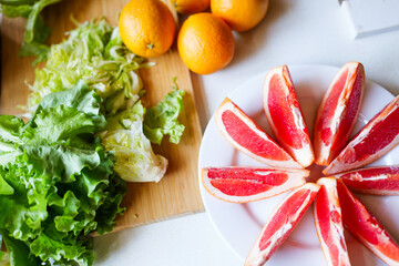 Fresh and vibrant arrangement of vegetables and fruits on a kitchen table