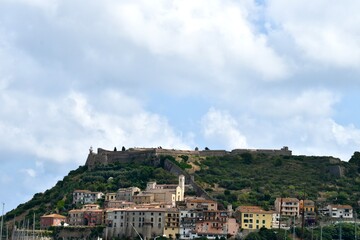 Obraz premium Porto Ercole and its Castle over the hill