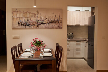 Cozy dining area with elegant table setting and artful decor in modern kitchen apartment