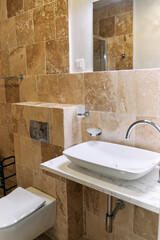 Modern bathroom with marble sink and tile walls featuring elegant design