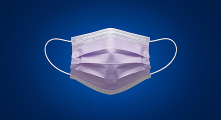 Medical face mask isolated on a blue background, protection and health concept, studio shot