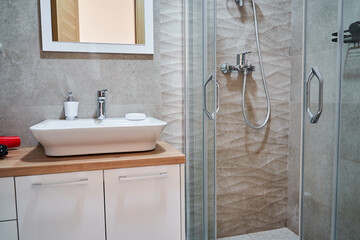 Modern bathroom interior design with vanity sink and glass shower enclosure