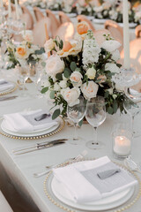Bride hand holding delicate wedding bouquet with roses