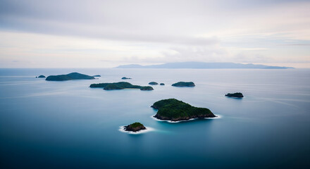 An aerial view of lush green islands scattered across a vast blue ocean