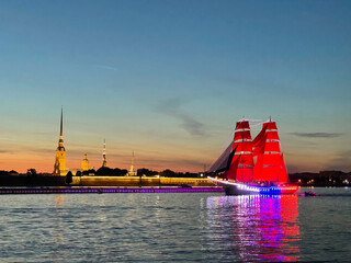 Rehearsal of the Scarlet Sails festival. Beautiful Brig Rossiya passing along the Neva River past the Peter and Paul Fortress during white night.
