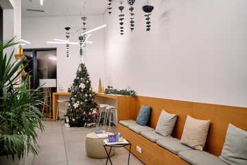 Modern office lounge with christmas tree and festive decorations