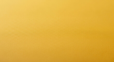 Bright amber surface showcases a beautiful background texture with a warm tone and granular effect for creative applications.