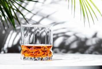 glass of rich scotch whiskey with vibrant reflections and natural light enhancing its amber hue